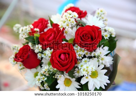 Bouquet of red roses among white flowers