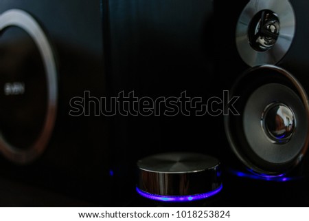 Music speakers with blue neon lights on a black background