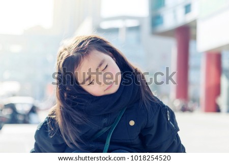 A lovely portrait of a little asian girl outside the mall
