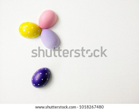 colored eggs on a white textured background