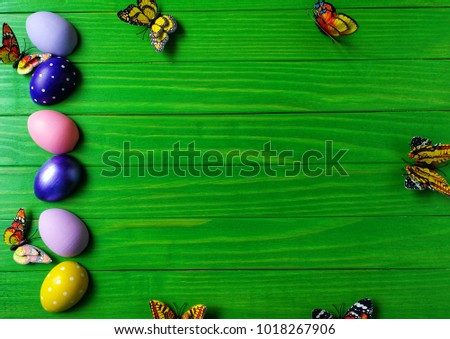 multicolored eggs on wooden green background