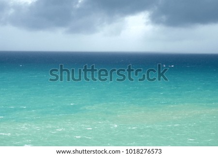 Dramatic turquoise sea in rainy day