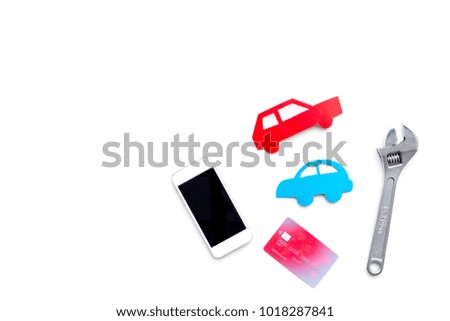 Search car service online. Mobile pay. Car silhouette, wrench, cell phone, bank card on white backgound top view copy space