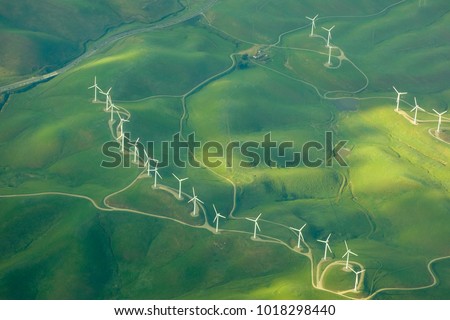 beautiful green aerial view of windmill farm providing eco-friendly energy sustainability  Royalty-Free Stock Photo #1018298440
