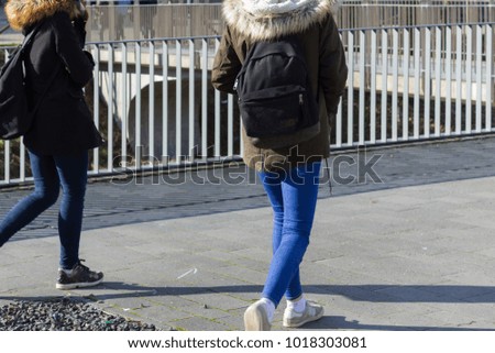 people walking in city park at february sunny winter afternoon in a historical city of south germany