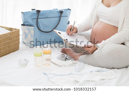 Prenatal pregnant women planning calendar and checklist appliance for baby, Preparing utensils for pregnancy concept Royalty-Free Stock Photo #1018332157