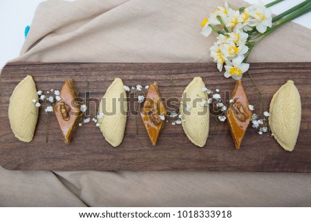 Traditional shekerbura and pakhlava as Novruz symbol on wooden board
