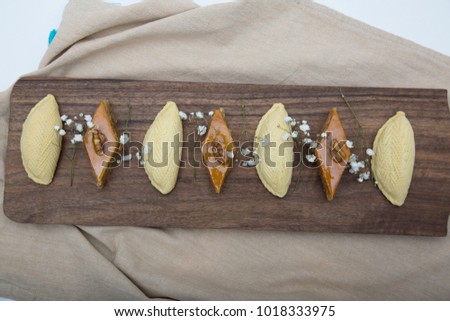 Traditional shekerbura and pakhlava as Novruz symbol on wooden board