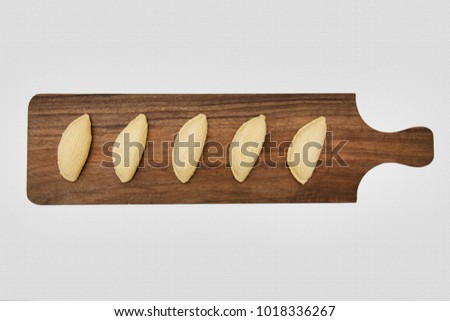 Traditional shekerbura as Novruz symbol on wooden board
