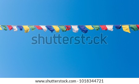 Colorful flags with vivid color use as tailsman for safety travel in tibetan on blue sky background Royalty-Free Stock Photo #1018344721