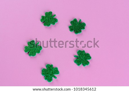 St. Patrick`s day background.Saint Patrick's Day shiny green clover ornament.Space for text.Flat lay.