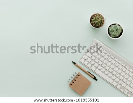 Simple Trendy Office Desk with keyboard, eco craft office elements and potted flower. Home Office Desktop Royalty-Free Stock Photo #1018355101