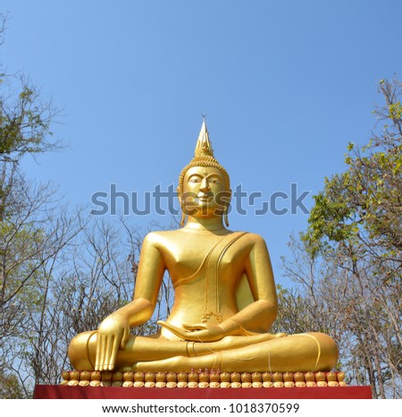 Golden Buddha statue background blue sky