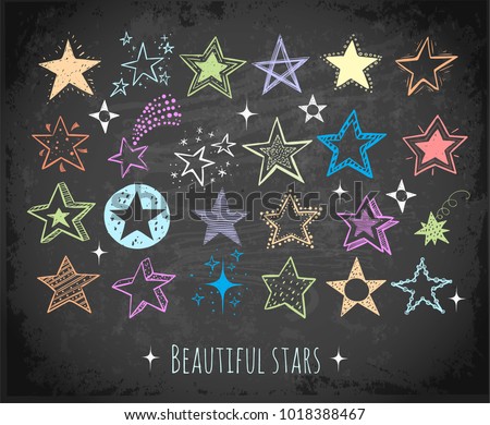 Collection of colored doodle stars on blackboard background
