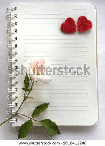 White notes with hearts and white roses.