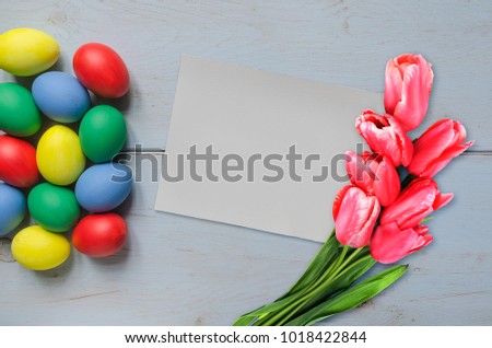 Easter eggs different color and blank card with tulips