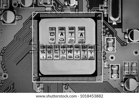Macro photo of circuit board and chip with DATA SECURITY words imprinted on metal surface
