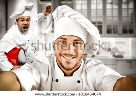 The cook's helper takes a picture of herself and the chef.