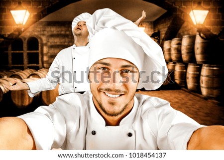 The cook's helper takes a picture of herself and the chef.