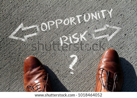 Top view on a man standing in front of the words "Risk" and "Opportunity" with arrows pointing to the left and right side of the picture Royalty-Free Stock Photo #1018464052
