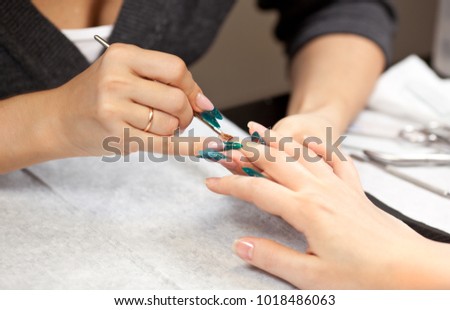 Picture of woman at manicure procedure at spa salon
