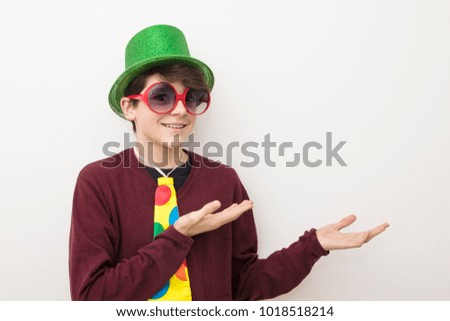 young man in clothes and carnival costume on white background
