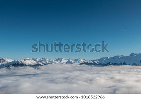 Snow on the top of the mountains and fog down the valley Royalty-Free Stock Photo #1018522966