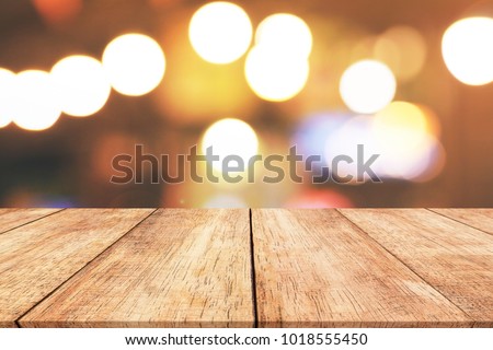 Wood table top with blurred light bokeh abstract background