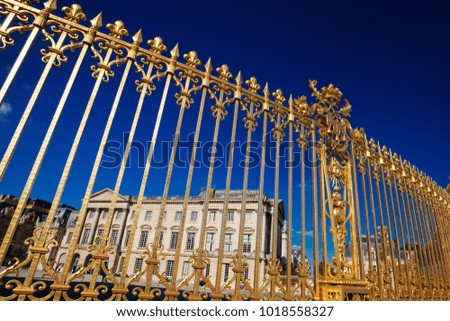 View of the part of a north wing of the Palace of Versailles across his gilding fence on the background of the sky, France
