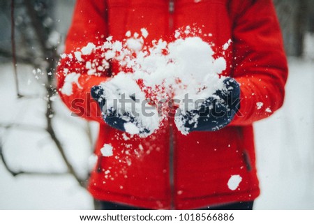 A young woman playing in the snow