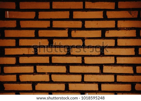 Underexposure and de focused Brown bricks Wall. Brown Background. Vintage Background.