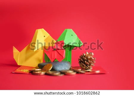 Creative lay out Chinese New Year 2018. Dog and rabbit paper origami in red background.Dog and rabbit origami with copy space.Selective Focus shot.