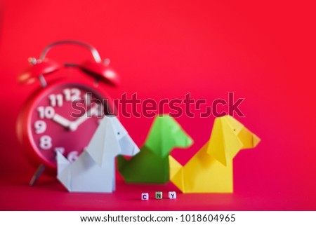 Creative lay out Chinese New Year 2018.Dog and rabbit paper origami in red background.Dog and rabbit origami with copy space.Selective Focus shot.
