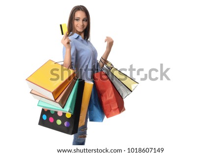 Shopping concept. Beautiful smiling brunette with shopping bags talking on the phone. isolated