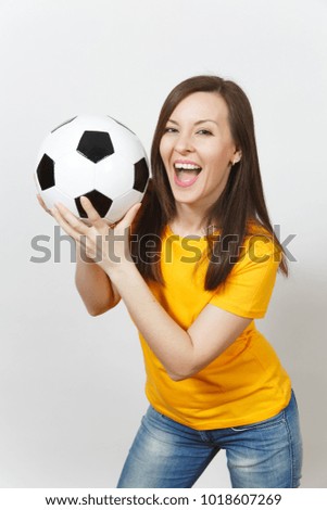 Close up pretty European young smiling happy woman, football fan or player in yellow uniform holding soccer ball isolated on white background. Sport, play football, health, healthy lifestyle concept