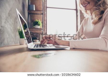 Cropped closeup photo of elegant woman's hands typing and searching information on the internet using her netbook