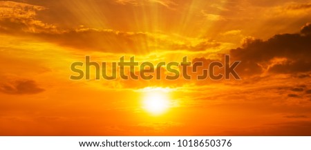 Gorgeous panorama scenic of the strong sunrise with silver lining and cloud on the orange sky Royalty-Free Stock Photo #1018650376