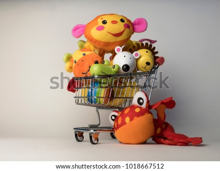 Shopping trolley cart with toys inside, cost of having a child, cute faces Royalty-Free Stock Photo #1018667512