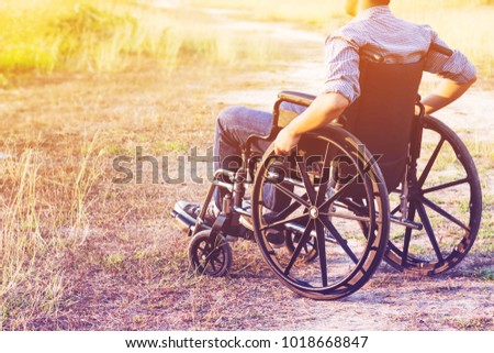Paralyzed man using Wheelchair outdoor  Royalty-Free Stock Photo #1018668847