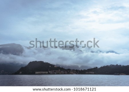 Cloudy Lake Como in Italy landscape Mountains background blue water clear cloudy sky Milano Lago di Como menaggio Belaggio  hotel tourism