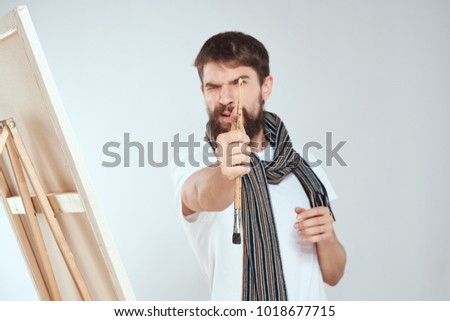 painter with a brush on a light background                              