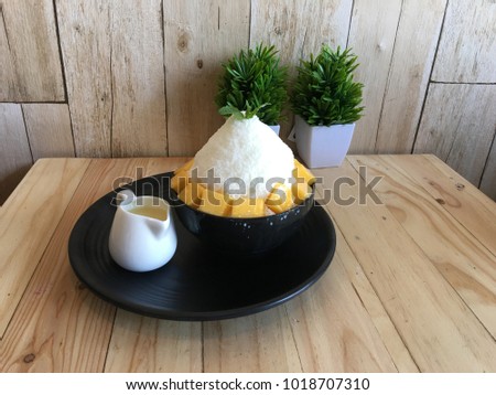 ice cream Bingsu Korea food mango served with sweetened condensed milk on table dessert Royalty-Free Stock Photo #1018707310