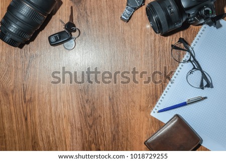Photographer travel accessories including a film camera on the table. Top view with copy space, flat lay
