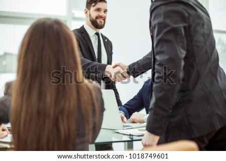 handshake business partners before discussing a new contract