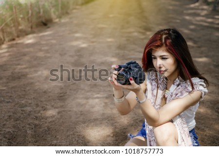 girl taking photo at park outdoor with copy space.
