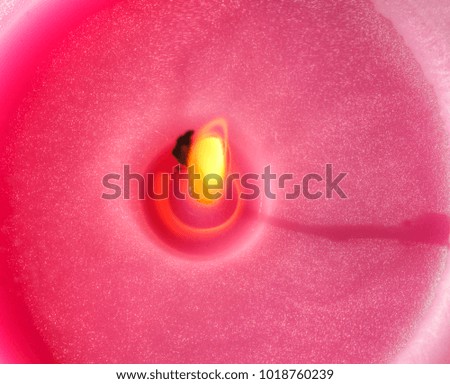 pink colored candle with candle Flame
