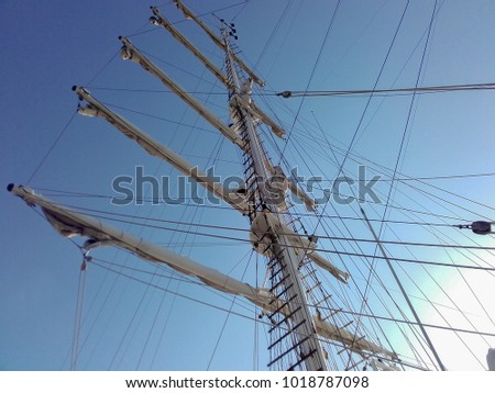 Masts of ship sailboat with folded sails occupying the whole setting in horizontal