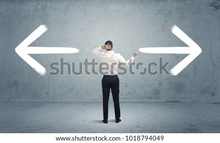 A businessman in doubt, having to shoose between two different choices indicated by arrows pointing in opposite direction concept