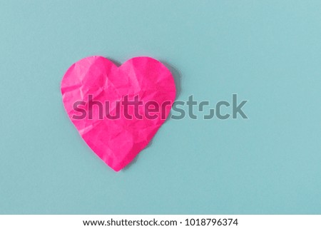 Heart of pink crumpled paper on a bright background. Card with space for text.