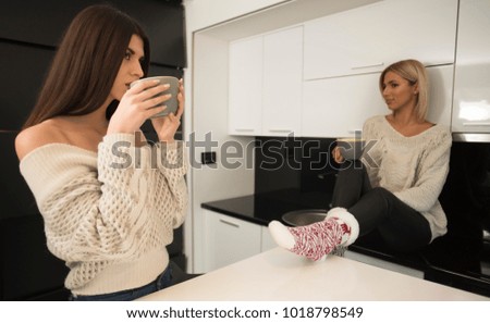 two best female friends drinking tea and talking in a kitchen. life stile concept